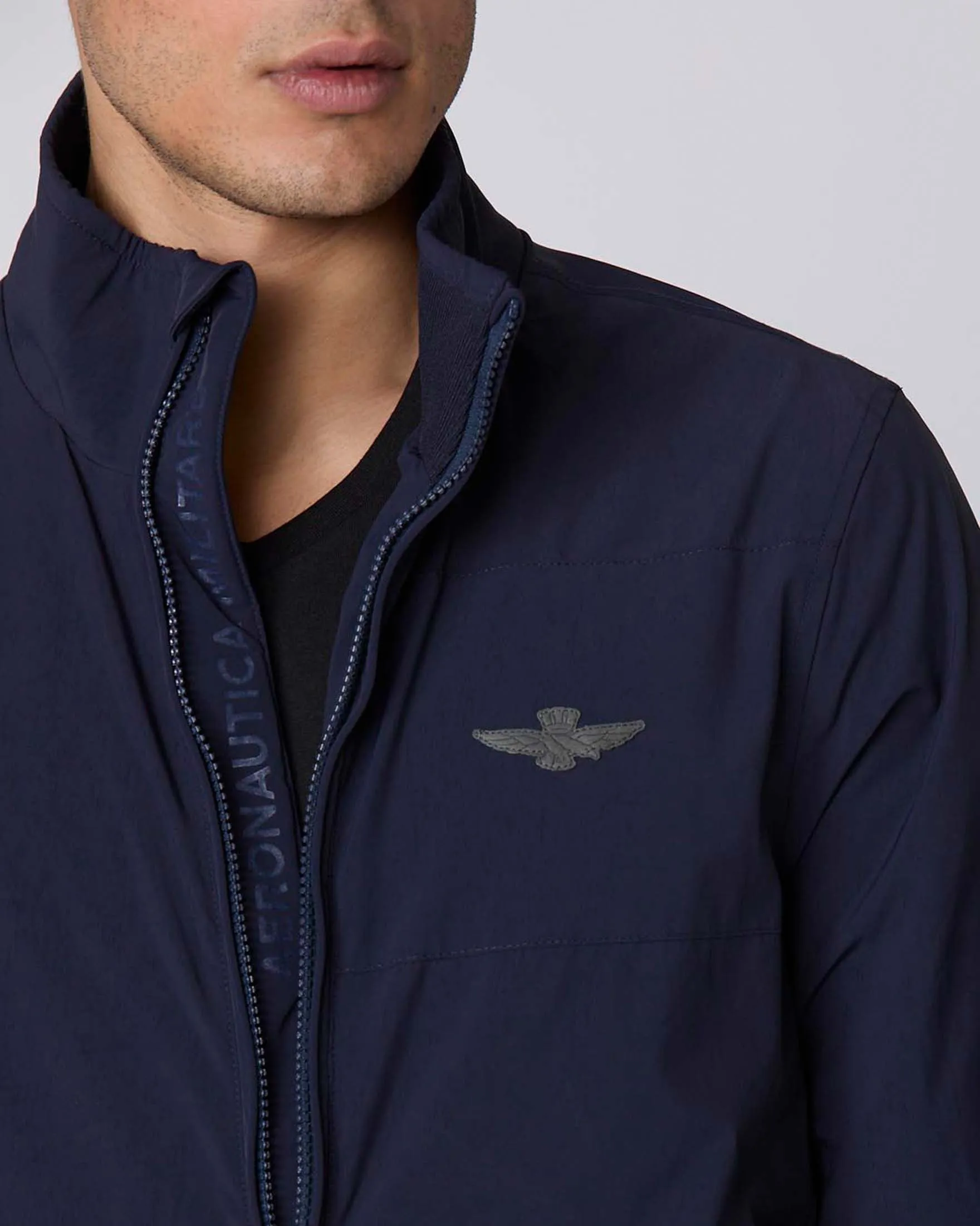 Giubbino bomber blu in tessuto stretch con ricamo aquila turrita