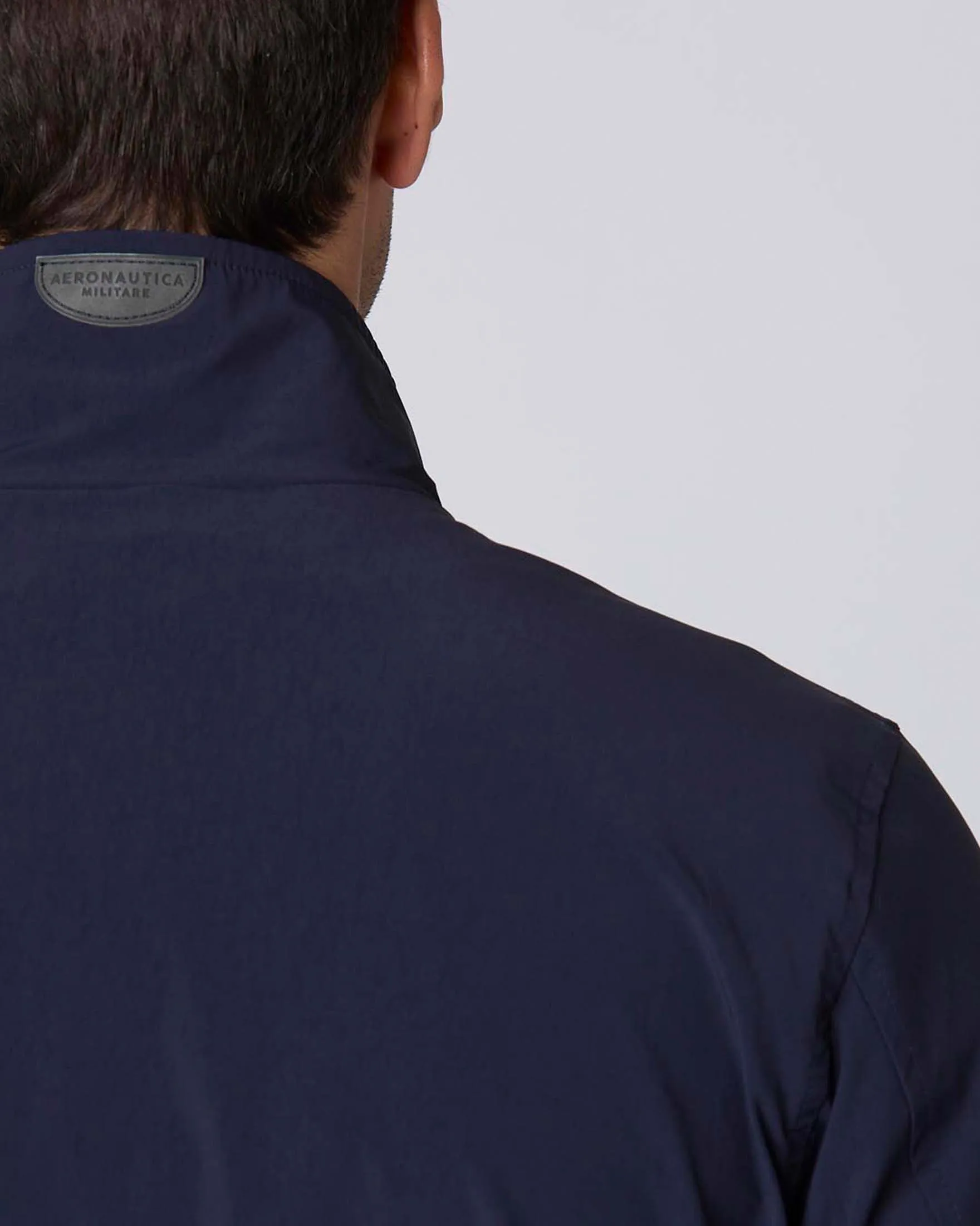 Giubbino bomber blu in tessuto stretch con ricamo aquila turrita